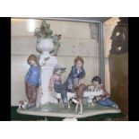 A large figural Lladro group of children playing o