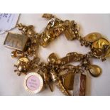 A 9ct charm bracelet with 1927 gold sovereign coin