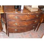 A bow front three drawer chest