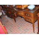 An Edwardian desk with five drawers to the front