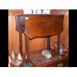 A small drop leaf antique table