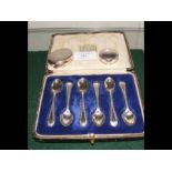 A set of silver cased teaspoons together with two