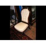 A Victorian nursing chair with carved cabriole fro