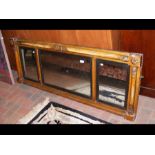 An antique triple over-mantel mirror with column s