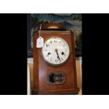 A 1930's oak cased mantel clock with metal dome be