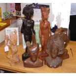 A collection of carved tribal figures and busts