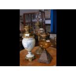 A Victorian oil lamp together with two others