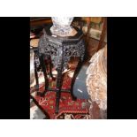 A 92cm high carved Chinese hardwood plant stand wi
