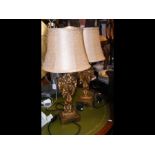 A pair of gilt wood table lamps with shades