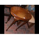 An oval mahogany occasional table on cabriole legs