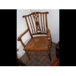 A late 19th century cane seated armchair with comb