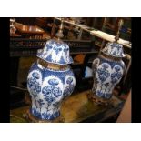 A pair of decorative blue and white table lamps wi