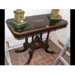 A Victorian ebonised centre table with shaped unde