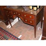 An Edwardian desk with five drawers to the front