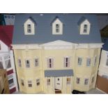 A large cream doll's house with boxed contents