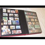 A stamp album containing UK, Guernsey and other st