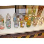 Fourteen vintage advertising milk bottles