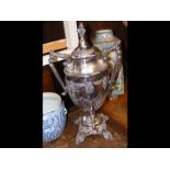 A silver plated two handled urn and cover