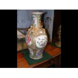 An antique Famille Rose vase - 46cms high with bir