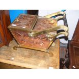 An antique hammered copper and brass coal scuttle