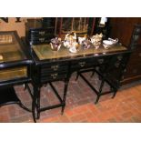 An Edwardian ebonised desk with green leather top