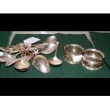 An assortment of silver teaspoons, two napkin ring