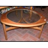 A retro G-Plan style glass top coffee table