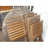 A circular garden table and four matching chairs,