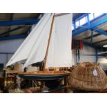 A model sailing boat and decorative lobster pot