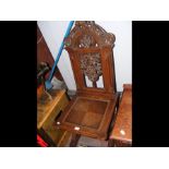An antique ecclesiastical style hall chair