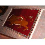 A Ghashie red ground rug with lion and sabre desig