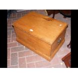 A small antique pine chest with handles to the sid