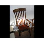 A Windsor lath back armchair on turned supports