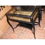 An ebonised display cabinet on cabriole supports -