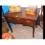 An antique Georgian lowboy with three drawers to t