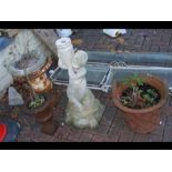 Two metal urns, a concrete bird bath and a terraco