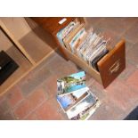 An oak filing drawer containing vintage postcards