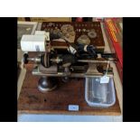 A vintage watch makers lathe with accessories