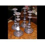 A set of four silver plated candlesticks - 28cm hi