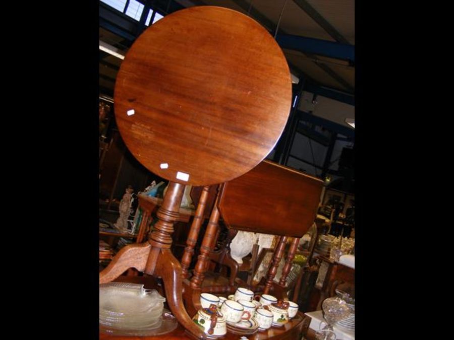 A mahogany tripod table together with a Sutherland