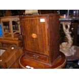 An oak smoker's cabinet with Dunhill tobacco jar