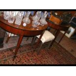A pair of antique half round hall tables with cros