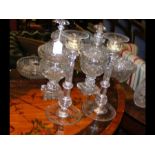 A pair of 32cm cut glass candlesticks, together wi