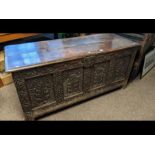 An 19th century carved oak coffer with four panels