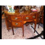 An antique bow fronted mahogany sideboard with mul
