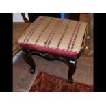 An antique stool with cabriole supports