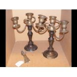 A pair of silver plated candelabra, together with