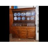 A Georgian oak dresser with plate rack over, drawe