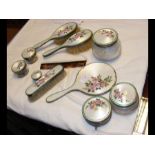 A silver and enamel dressing table set