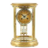 A LATE 19TH CENTURY FRENCH OVAL BRASS AND CHAMPLEVE ENAMEL MANTEL CLOCK